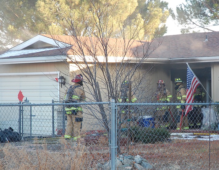 Firefighters clean up after a house fire in the 3400 block of North Dale Drive, Prescott Valley, on Sunday afternoon, Dec. 29, 2019. (Tim Wiederaenders/Courier)