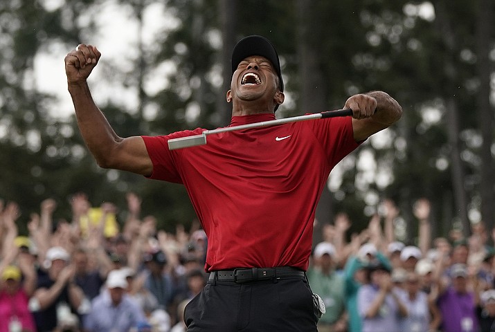 in this april 14, 2019 photo, tiger woods reacts as he wins the