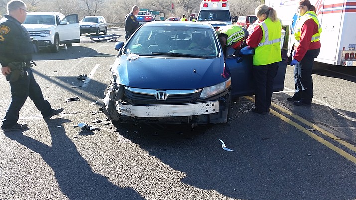 Emergency responders check the welfare of a driver whose car was involved in a head-on collision along Montezuma St. Monday, Dec. 30. (PPD/Courtesy)