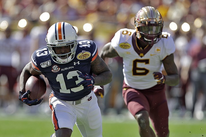 Auburn defensive back Javaris Davis (13) runs with the football after intercepting a pass intended for Minnesota wide receiver Tyler Johnson (6) during the first half of the Outback Bowl NCAA college football game Wednesday, Jan. 1, 2020, in Tampa, Fla. (Chris O'Meara/AP)