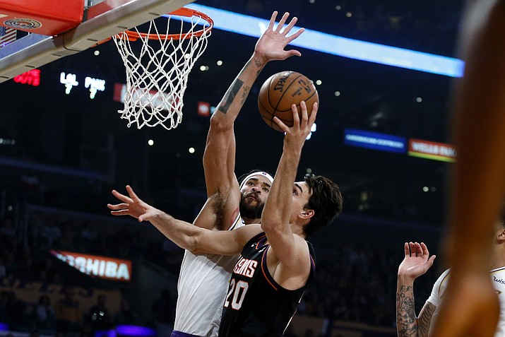 Phoenix Suns' Dario Saric (20) goes up to the basket under pressure from Los Angeles Lakers' JaVale McGee during the first half of an NBA basketball game Wednesday, Jan. 1, 2020, in Los Angeles. (Ringo H.W. Chiu/AP)