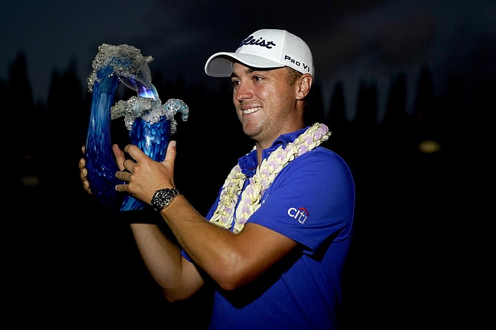 Justin Thomas holds the champions trophy after winning Tournament of Champions golf event, Sunday, Jan. 5, 2020, at Kapalua Plantation Course in Kapalua, Hawaii. Thomas won after a three-hole playoff. (Matt York/AP)
