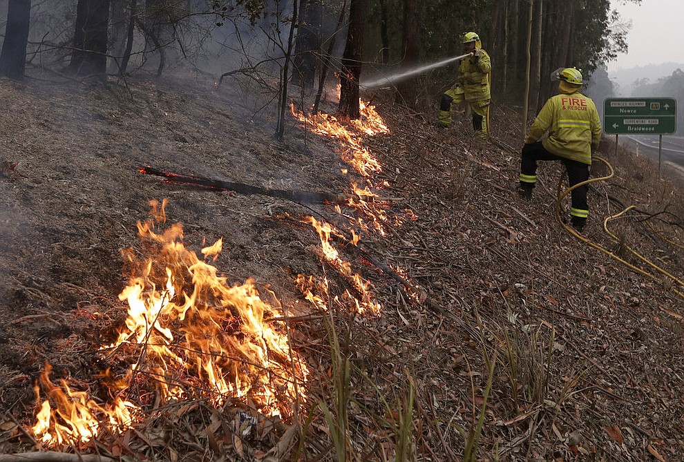 Firefighters manage a controlled burn to help contain a larger fire near Falls Creek, Australia, Sunday, Jan. 5, 2020. The deadly wildfires, which have been raging since September, have already burned about 5 million hectares (12.35 million acres) of land and destroyed more than 1,500 homes. (AP Photo/Rick Rycroft)