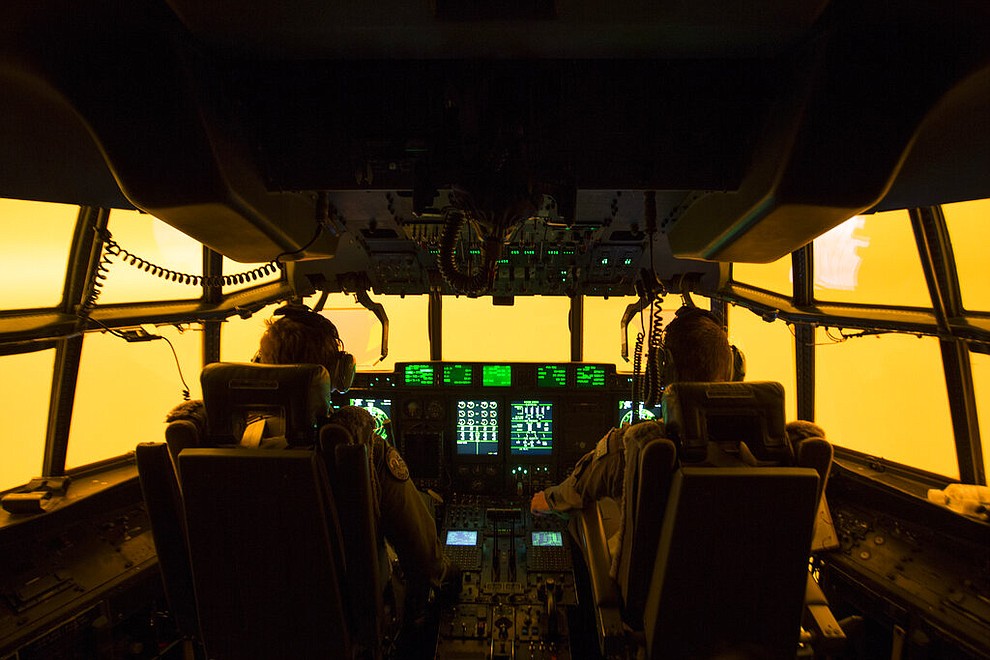 In this Sunday, Jan. 5, 2020, photo provided by Australian Department of Defence, the flight deck of a C-130J Hercules aircraft has a warm glow from wildfires, as they prepare to land at Merimbula airfield to deploy Fire and Rescue crews. The wildfires have so far scorched an area twice the size of the U.S. state of Maryland. (SGT Christopher Dickson/ADF via AP)