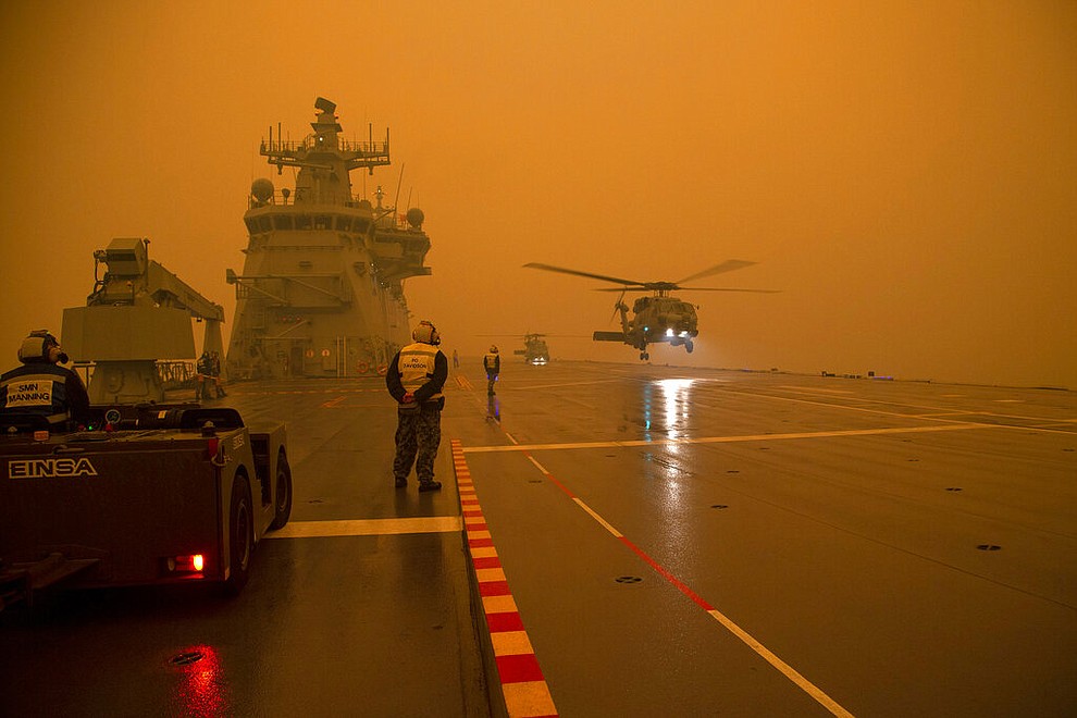 In this photo provided by the Australian Department of Defence, a Royal Australian Navy Seahawk Helicopter departs from HMAS Adelaide while at sea off Australia's east coast, Sunday, Jan. 5, 2020, during operations to assist in battling wildfires. The wildfires have so far scorched an area twice the size of the U.S. state of Maryland. (Able Seaman Thomas Sawtell/ADF via AP)