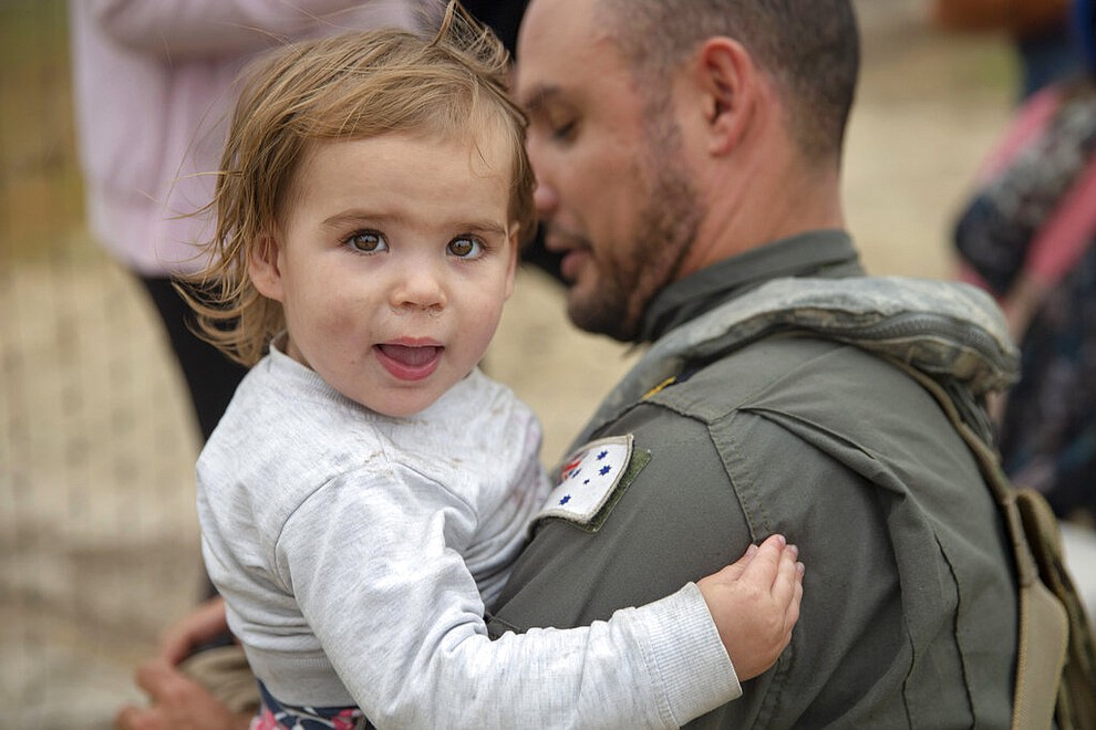In this photo provided by the Australian Department of Defence, a child is helped onto a helicopter as the fire ravaged community of Mallacoota is evacuated, Sunday, Jan. 5, 2020. The wildfires have so far scorched an area twice the size of the U.S. state of Maryland. (Corporal Nicole Dorrett/ADF via AP)
