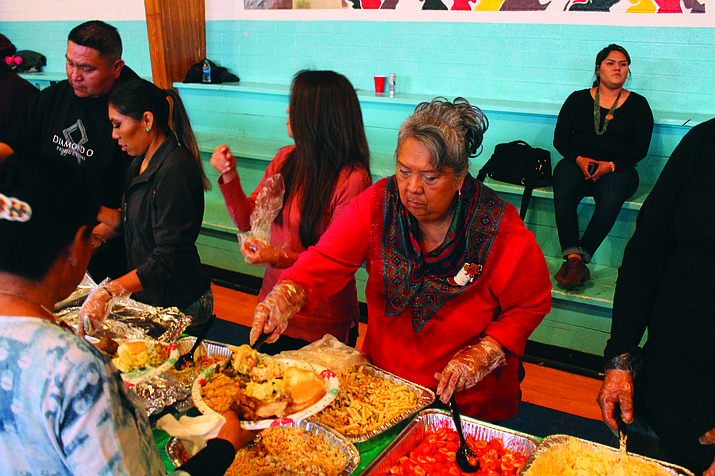 Volunteer Ivy Multine serves food to attendees at the Community Christmas Dinner Dec. 25, in Tuba City, Arizona.  (Photo/Joshua Lavar Butler)