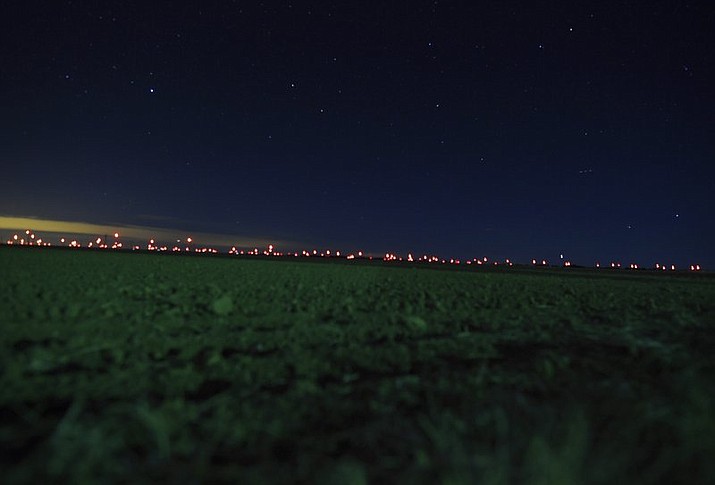 This Jan. 2, 2020, photo shows red lights from wind turbines￼￼￼ in the distance in the area of Genoa and Hugo, Colo., where sightings of unidentified large drones in the air have been reported. An official investigation into reports of large drones flying in groups over the western U.S. plains in the hours after sunset has confirmed nothing illegal or out of the ordinary, a finding of little solace to folks who say the truth is still out there. Investigators will scale back flights of a heat-detecting plane to try to corroborate reports as they're made but will continue to look into new reports, Colorado officials said Tuesday, Jan. 14. (RJ Sangosti/The Denver Post via AP)