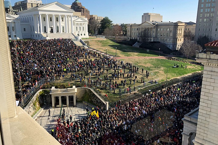 Demonstrators are seen during a pro-gun rally, Monday, Jan. 20, 2020, in Richmond, Va. Thousands of pro-gun supporters are expected at the rally to oppose gun control legislation like universal background checks that are being pushed by the newly elected Democratic legislature. (Sarah Rankin/AP Photo)