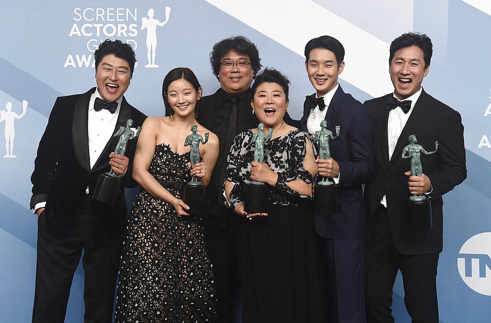 Kang-Ho Song, from left, Park So-dam, Bong Joon-ho, Jang Hye-jin, Choi Woo-shik, and Lee Sun Gyun pose in the press room with the award for outstanding performance by a cast in a motion picture for "Parasite" at the 26th annual Screen Actors Guild Awards at the Shrine Auditorium & Expo Hall on Sunday, Jan. 19, 2020, in Los Angeles. (Photo by Jordan Strauss/Invision/AP)