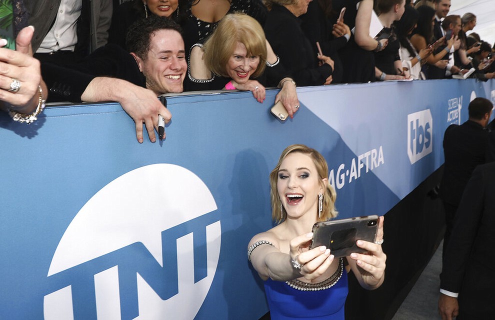 Rachel Brosnahan takes a selfie with fans as she arrives at the 26th annual Screen Actors Guild Awards at the Shrine Auditorium & Expo Hall on Sunday, Jan. 19, 2020, in Los Angeles. (Photo by Matt Sayles/Invision/AP)