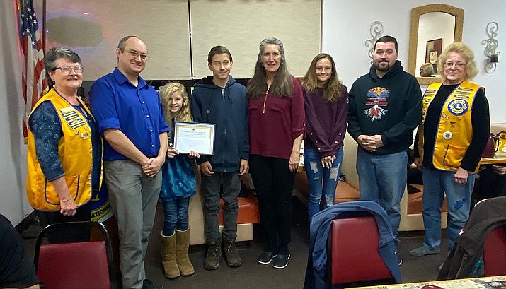 Members of the Prescott Valley Early Bird Lions Club gather to honor local students at a recent event. The club will be collecting used eyeglasses on Saturday, Jan. 25 at the Sally B's and Denny's restaurants in Prescott Valley. (Prescott Valley Chamber of Commerce/Courtesy)