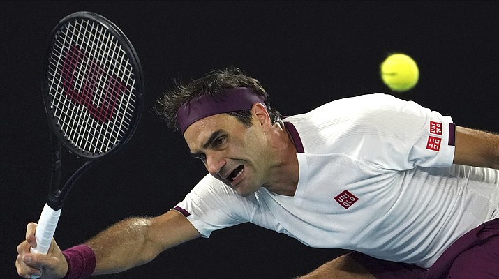 Switzerland's Roger Federer makes a forehand return to Hungary's Marton Fucsovics during their fourth round singles match at the Australian Open tennis championship in Melbourne, Australia, Sunday, Jan. 26, 2020. (AP Photo/Lee Jin-man)