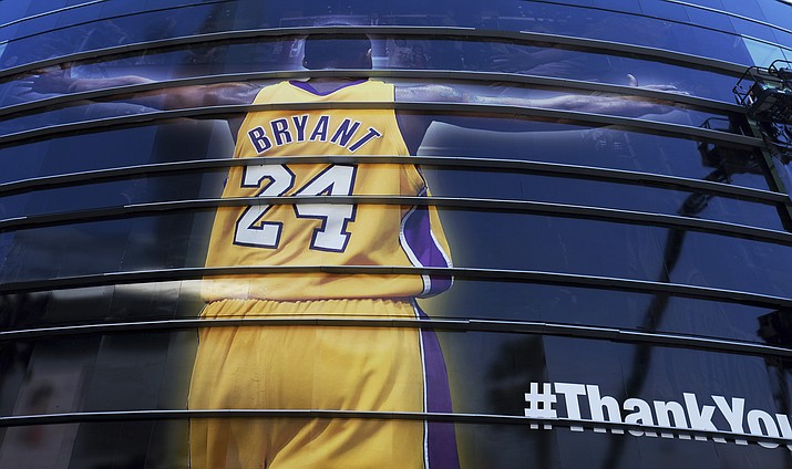 In this April 13, 2016, file photo, a giant banner congratulating Kobe Bryant is draped around Staples Center before his last NBA basketball game in downtown Los Angeles. Bryant, the 18-time NBA All-Star who won five championships and became one of the greatest basketball players of his generation during a 20-year career with the Los Angeles Lakers, died in a helicopter crash Sunday, Jan. 26, 2020. (AP Photo/Richard Vogel, File)