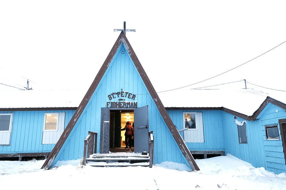 A woman arrives for services at the St. Peter Fisherman Church, Sunday, Jan. 19, 2020, in Toksook Bay, Alaska. The first Americans to be counted in the 2020 Census starting Tuesday, Jan. 21, live in this Bering Sea coastal village. (AP Photo/Gregory Bull)