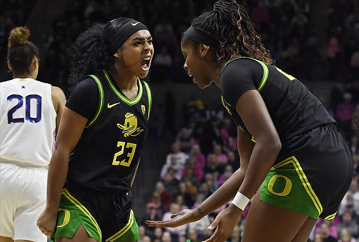 Oregon's Minyon Moore (23) reacts toward teammate Oregon's Ruthy Hebard, right, in the first half of an NCAA college basketball game against Connecticut, Monday, Feb. 3, 2020, in Storrs, Conn. (Jessica Hill/AP)