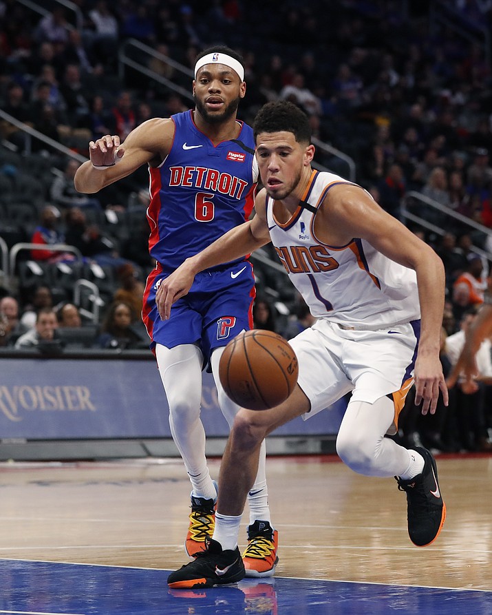 Phoenix Suns guard Devin Booker (1) chases the loose ball next to Detroit Pistons guard Bruce Brown (6) during the first half of a game, Wednesday, Feb. 5, 2020, in Detroit. (Carlos Osorio/AP)