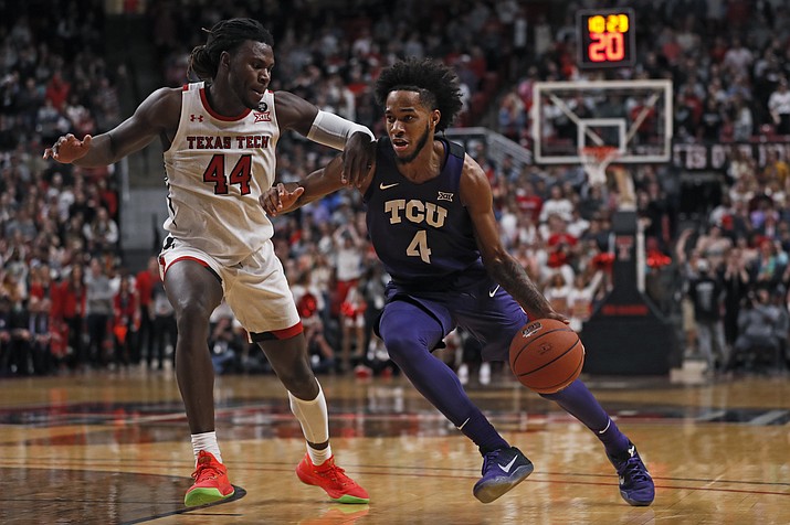 TCU's PJ Fuller (4) dribbles around Texas Tech's Chris Clarke (44) during the first half of an NCAA college basketball game Monday, Feb. 10, 2020, in Lubbock, Texas. (AP Photo/Brad Tollefson)