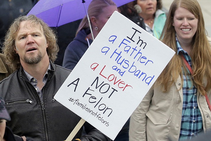Kody Brown, left, from TV's reality show "Sister Wives," marches during a protest at the state Capitol, in Salt Lake City in 2017. Polygamists have lived in Utah since before it became a state, and 85 years after the practice was declared a felony they still number in the thousands. It's even been featured in the long-running reality TV show, "Sister Wives." Now, a state lawmaker says it's time to remove the threat of jail time for otherwise law-abiding polygamists. (AP Photo/Rick Bowmer, File)