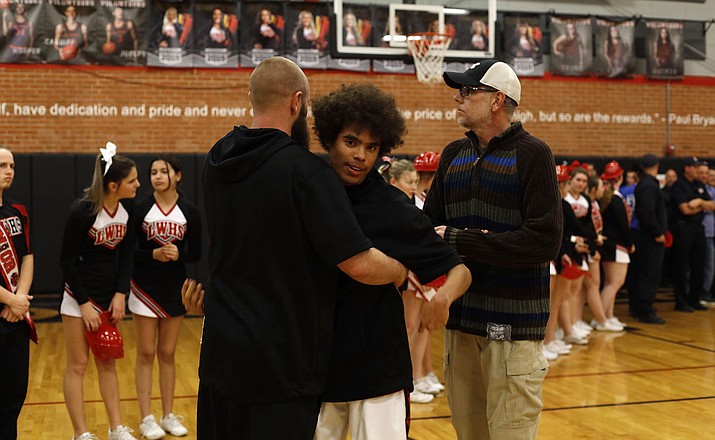 Lee Williams' Jace Brooks hugs coach Cain Atkinson during Senior Night festivities. Brooks scored his first points of the season Tuesday in a win over Mingus. (Photo courtesy of Lisa McClung)