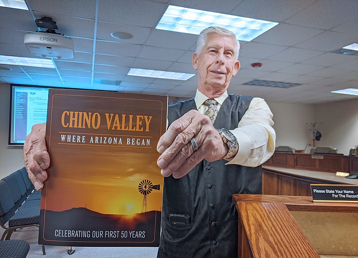 Town Council member Mike Best shows off a copy of "Chino Valley, Where Arizona Began" at a recent Town Council Meeting. The book commemorates the 50th Anniversary of the Towns incorporation in Sept. 1970. Best serves as the 50th Anniversary Committee co-char along with fellow council member Jack Miller, and also served on the books Editorial Committee. (Courtesy)