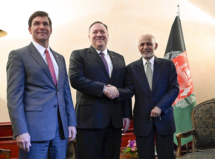 US Secretary of State Mike Pompeo, center, shakes hands with Afghan President Ashraf Ghani, right, as US Secretary of Defense Mark Esper watches during the 56th Munich Security Conference (MSC) in Munich, southern Germany, on Friday, Feb. 14, 2020. The 2020 edition of the Munich Security Conference (MSC) takes place from Feb. 14 to 16. (Andrew Caballero-Reynolds/Pool photo via AP)
