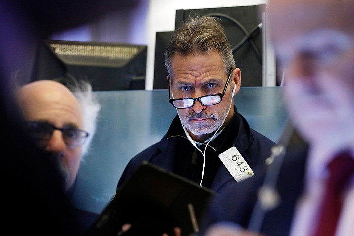Trader Ronald Madarasz works on the floor of the New York Stock Exchange, Friday, Feb. 14, 2020. U.S. stocks wobbled between small gains and losses in early trading Friday as investors focused on another round of mostly solid corporate earnings. (AP Photo/Richard Drew)