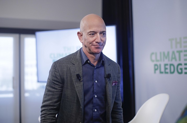 In this Thursday, Sept. 19, 2019 file photo, Amazon CEO Jeff Bezos walks off stage after holding a news conference at the National Press Club in Washington to announce the Climate Pledge, setting a goal to meet the Paris Agreement 10 years early. On Monday, Feb. 17, 2020, Bezos said that he plans to spend $10 billion of his own fortune to help fight climate change. (Pablo Martinez Monsivais/AP)