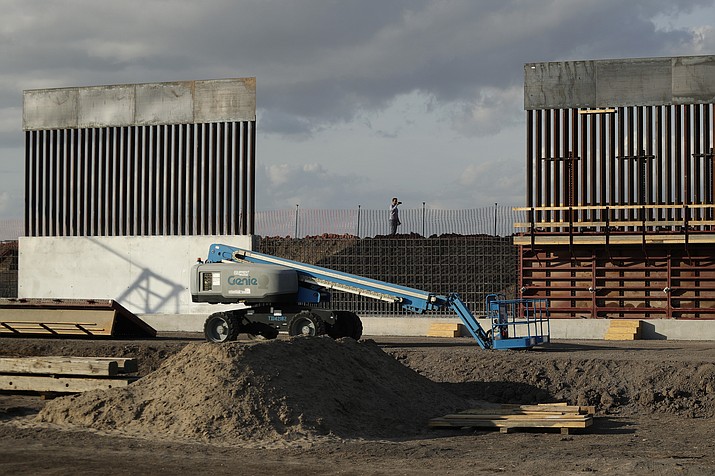 FILE - In this Nov. 7, 2019 file photo, the first panels of levee border wall are seen at a construction site along the U.S.-Mexico border, in Donna, Texas. The Trump administration said Tuesday, Feb. 18, 2020, that it will waive federal contracting laws to speed construction of the border wall with Mexico. (AP Photo/Eric Gay, File)