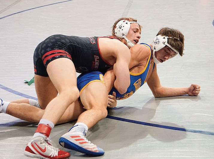 Lee Williams senior Jimmy Wayman, top, works a move during the Division III State Championship tournament in Prescott Valley. Wayman won all four of his matches to take first in the 145-pound bracket. (Photo by Aaron Valdez/For the Miner)