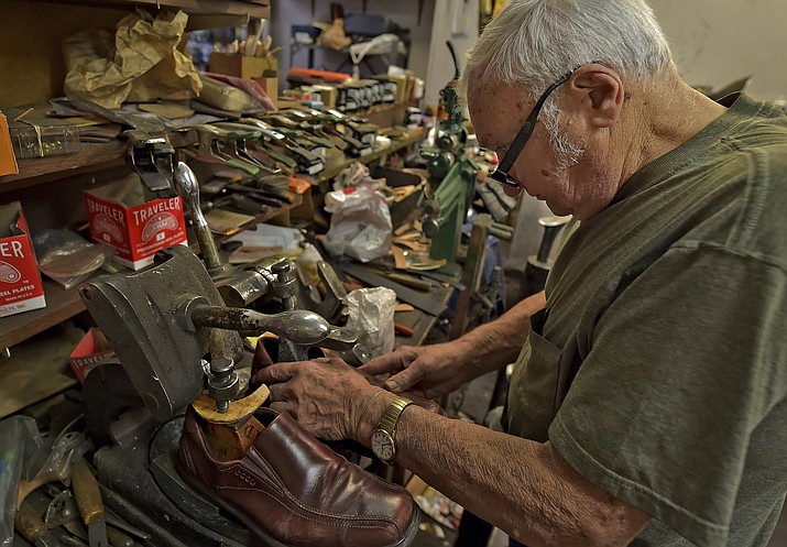 In this Jan. 29, 2020, file photo, Tony Bonczewski repairs a heel on a customer's shoe at his cobbler shop in Wilkes-Barre, Pa. Small business owners have received some upbeat news on the economy this month. Retail sales figures released Friday showed that consumers were inspired by unseasonably warm weather to spend on their homes in January, but that overall sales growth was modest. (Aimee Dilger/The Times Leader via AP, File)
