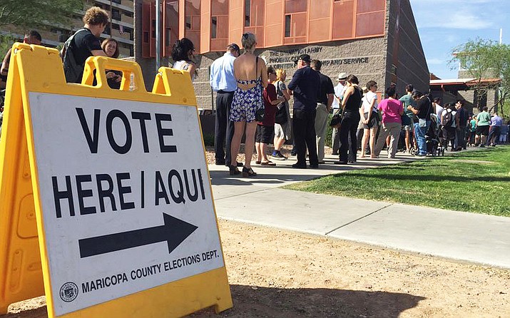 A federal court struck down Arizona laws on ballot harvesting and out-of-precinct voting that it said disproportionately harm minority voters. Among the problems are frequently shifting polling places that led to hours-long voting delays like those in the 2016 primaries, shown here. (Photo by Miguel Otarola/Cronkite News)