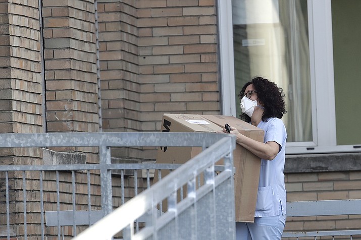 A nurse carries a box into the hospital of Codogno, near Lodi in Northern Italy, Friday, Feb. 21,2020. Health officials reported the country's first cases of contagion of COVID-19 in people who had not been in China. The hospital in Codogno is one of the hospitals - along with specialized Sacco Hospital in Milan - which is hosting the infected persons and the people that were in contact with them and are being isolated. (Luca Bruno/AP)