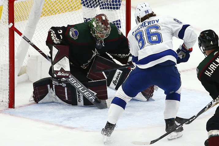 Arizona Coyotes goaltender Antti Raanta, left, makes a save on a shot by Tampa Bay Lightning right wing Nikita Kucherov (86) during the first period of a game Saturday, Feb. 22, 2020, in Glendale. (Ross D. Franklin/AP)