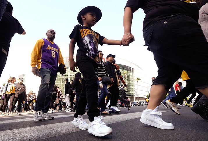 Fans leave the Staples Center after a public memorial for former Los Angeles Lakers star Kobe Bryant and his daughter, Gianna, in Los Angeles, Monday, Feb. 24, 2020. (Ringo H.W. Chiu/AP)