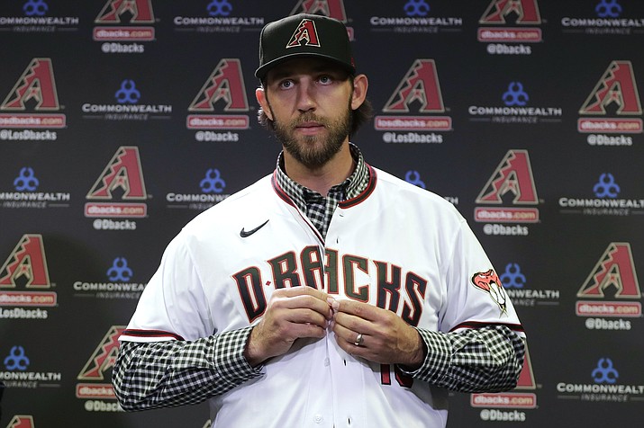 In this Dec. 17, 2019, file photo, newly acquired Arizona Diamondbacks pitcher Madison Bumgarner puts on Bumgarner lives on a ranch but were unaware of his recently-discovered side career as a rodeo participant.(Matt York, AP File)