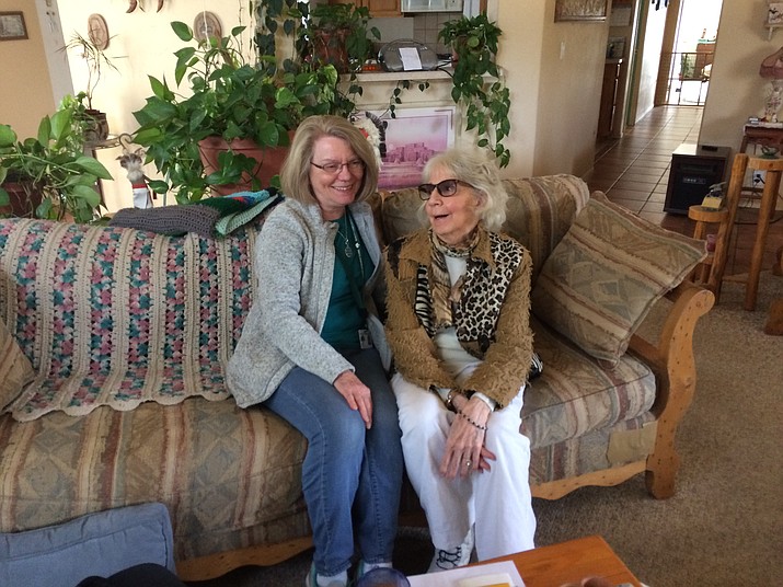 Bonnie Wolff, 69, Senior Peer program volunteer, chats with client Carmen Houssiere in her Williamson Valley home. Carmen, a 71-year-old retired clinical social worker, suffers from a degenerative eye ailment and leukemia. (Nanci Hutson/Courier)
