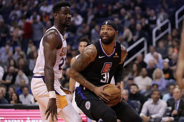 Los Angeles Clippers forward Marcus Morris Sr. (31) looks to shoot over Phoenix Suns center Deandre Ayton (22) during the first half of a game, Wednesday, Feb. 26, 2020, in Phoenix. (Matt York/AP)