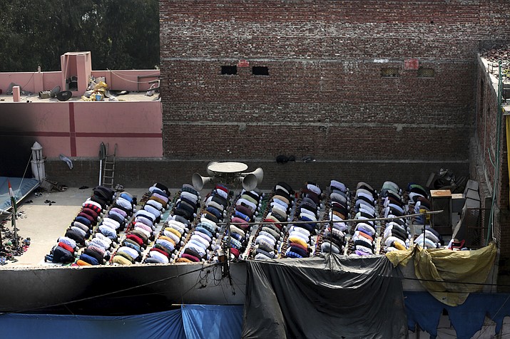 Muslims offer prayers on the roof of a fire-bombed mosque in New Delhi, India, Friday, Feb. 28, 2020. Muslims returned to the battle-torn streets of northeastern New Delhi for weekly prayers at heavily-policed fire-bombed mosques on Friday, two days after a 72-hour clash between Hindus and Muslims that left at least 38 dead and hundreds injured. (Altaf Qadri/AP)