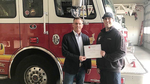 Prescott Mayor Greg Mengarelli stands with Prescott Fire Department engineer/paramedic Dave Haskell in one of the department’s fire stations. Both are holding a certificate stating that the department has been awarded the Premier Emergency Medical Services Agency status by the Arizona Department of Health Services Bureau of Emergency Medical Services and Trauma System. (PFD/Courtesy)