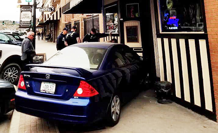 First responders check on an 84-year-old woman who drove her car over the street curb along Whiskey Row in Prescott and into the door of 1881 Spirits. (Hoyt Johnson III/Courtesy)