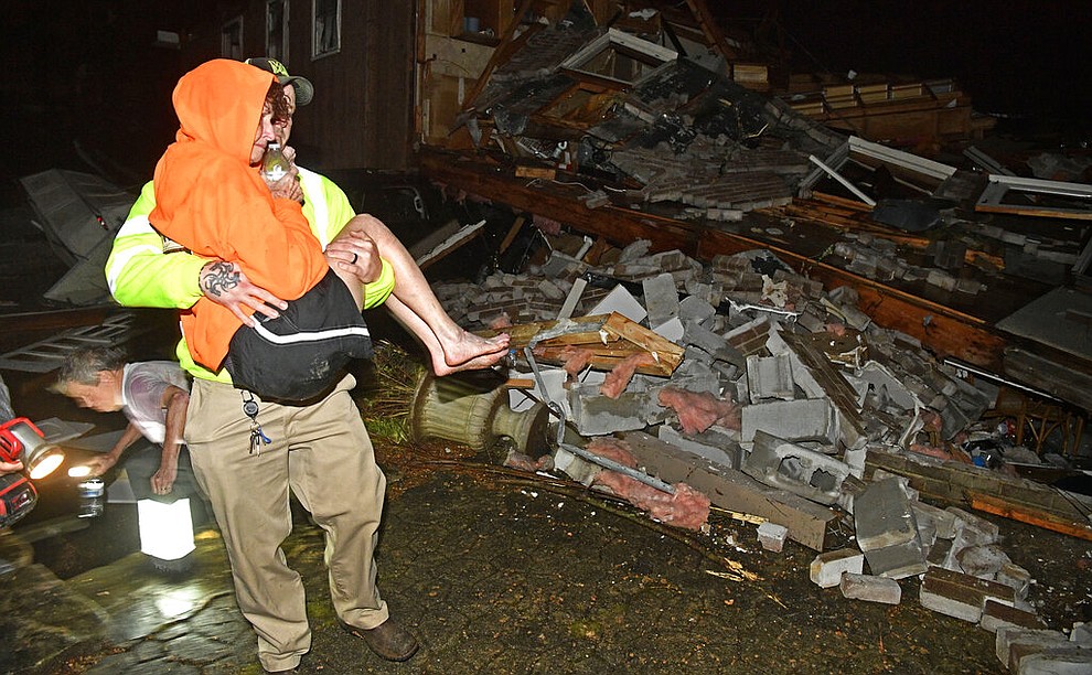 A rescue worker carries Shirley Wallace from her home that collapsed and trapped her under rubble after a tornado hit Mt. Juliet, Tenn., Tuesday, March 3 2020. (Larry McCormack/The Tennessean via AP)