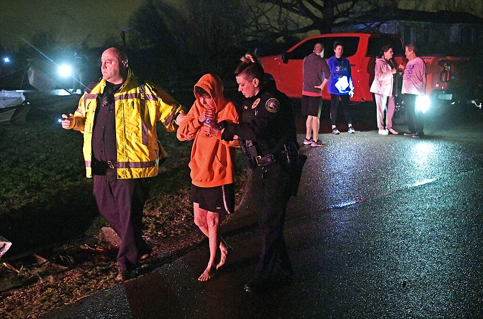 Rescue workers escort Shirley Wallace from her home that collapsed and trapped her under rubble after a tornado hit Mt. Juliet, Tenn., Tuesday, March 3 2020. (Larry McCormack/The Tennessean via AP)