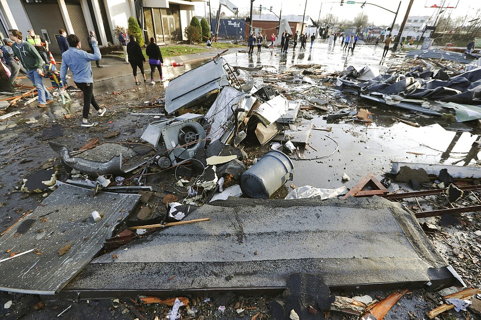 Debris covers a street after overnight storms Tuesday, March 3, 2020, in Nashville, Tenn. Tornadoes ripped across Tennessee early Tuesday, shredding buildings and killing multiple people. (AP Photo/Mark Humphrey)