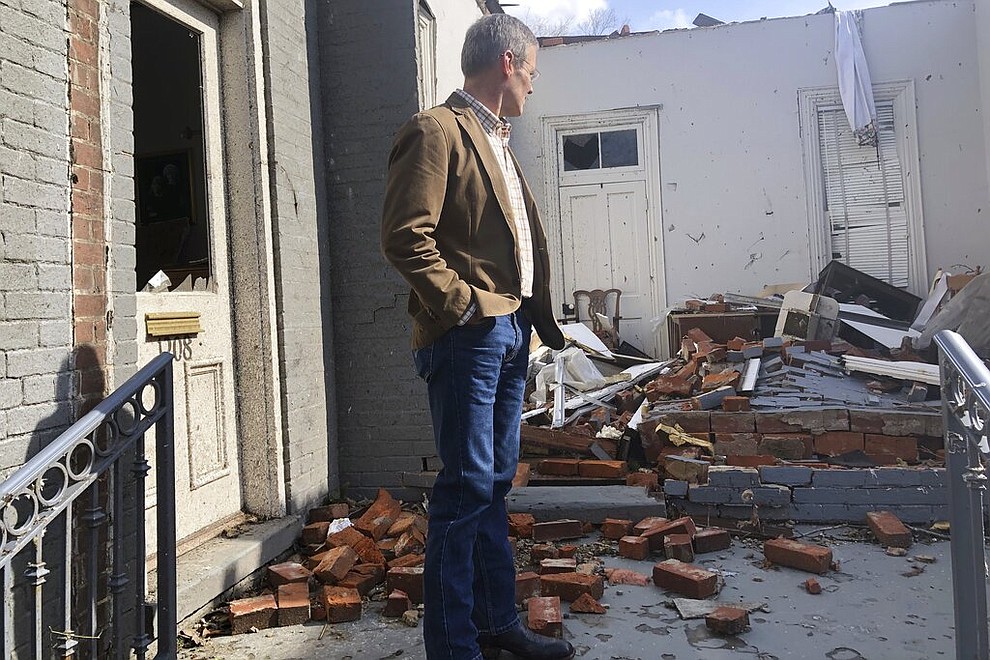 Tennessee Gov. Bill Lee surveys damage to buildings in Nashville, Tenn. on Tuesday, March 3, 2020. Tornadoes ripped across Tennessee early Tuesday, shredding at least 40 buildings and killing many people. One of the twisters caused severe damage across downtown Nashville, destroying the stained glass in a historic church and leaving hundreds of people homeless. (AP Photo/Travis Loller)