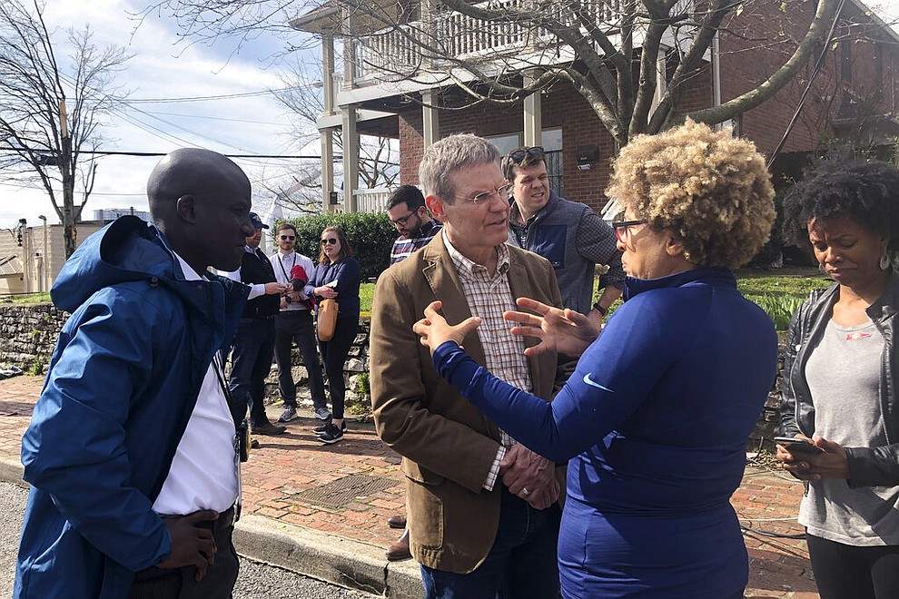 Tennessee Gov. Bill Lee speaks with business owner Mignon Francois, in Nashville, Tenn. on Tuesday, March 3, 2020. Tornadoes ripped across Tennessee early Tuesday, shredding at least 40 buildings and killing many people. One of the twisters caused severe damage across downtown Nashville and leaving hundreds of people homeless. (AP Photo/Travis Loller)