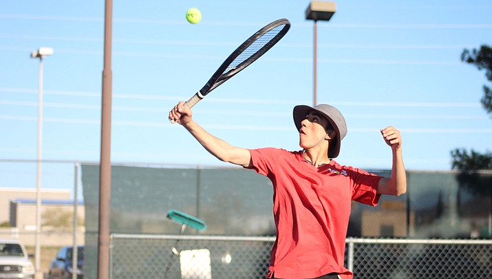 Lee Williams senior Brycen Rodriguez returns a serve Tuesday during his 6-0, 6-1 win at No. 5 singles. (Photo by Beau Bearden/Kingman Miner)