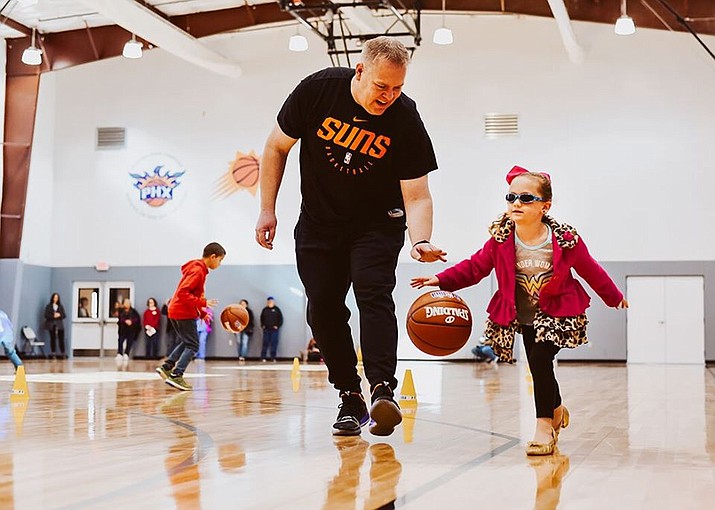A Northern Arizona Suns coach works with a little girl during a basketball camp in late November 2019 at the Boys & Girls Club in Prescott Valley. (Shana Oh/Courtesy)