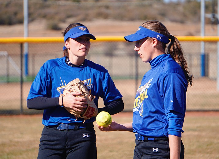 Embry-Ridde infielder Mikendra Kramer, left, has a conversation with designated player Haley Basye during a warm-up up drill at a team practice on Thursday, Feb. 26, 2020, at Embry-Riddle. (Aaron Valdez/Courier)