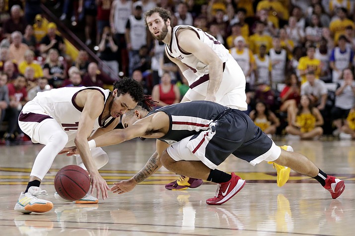 Arizona State guard Jaelen House, left, and Washington State guard Isaac Bonton, right battle for a loose ball during the first half of a game Saturday, March 7, 2020, in Tempe. (Matt York/AP)
